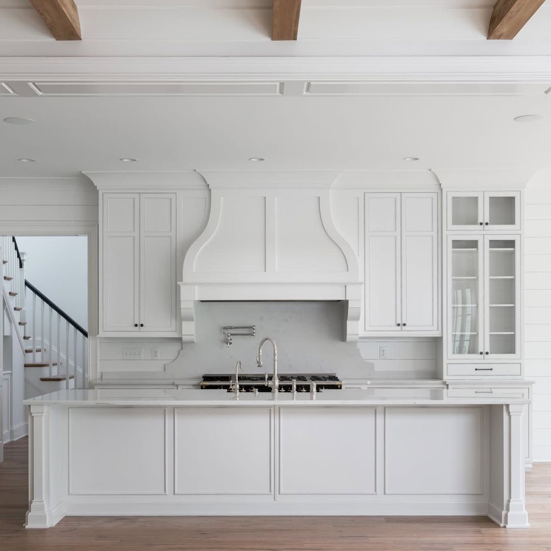 White Kitchen With Cane Stools and Patterned Tile