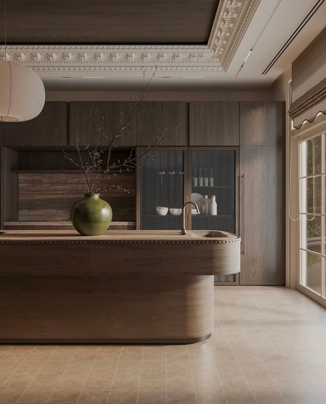 Luxurious kitchen featuring large rounded island and cool stools