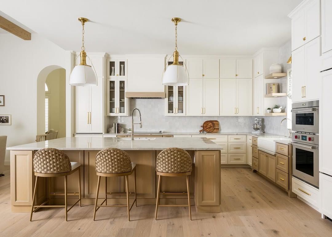 White Kitchen With Cane Stools and Patterned Tile