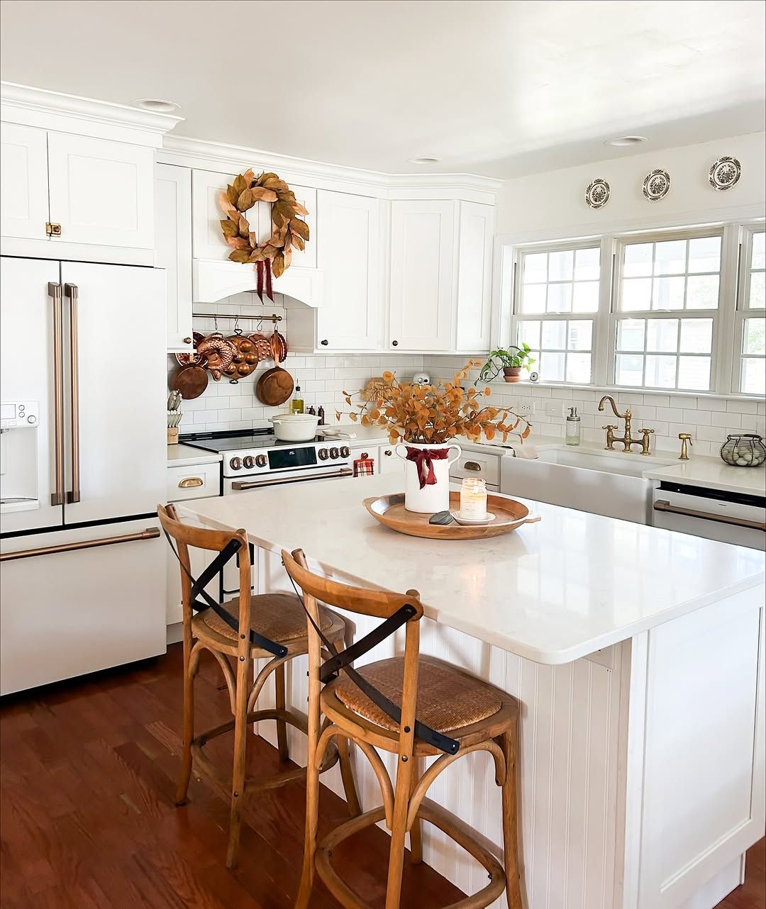 White Kitchen With Cane Stools and Patterned Tile