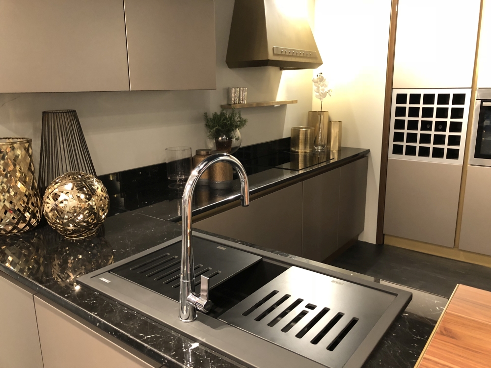 Stainless Sink Embedded Into a Dark Veined Countertop