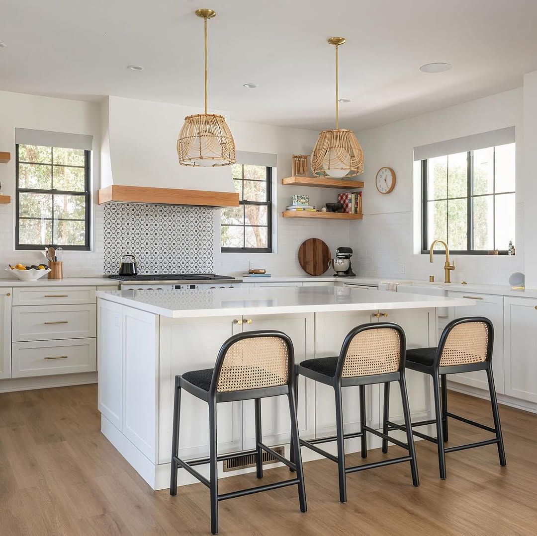 White Kitchen With Cane Stools and Patterned Tile