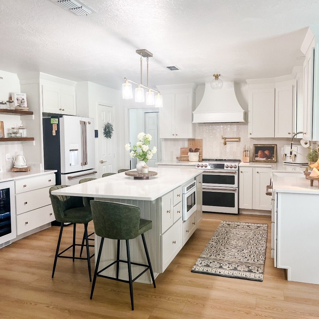 White Kitchen With Cane Stools and Patterned Tile
