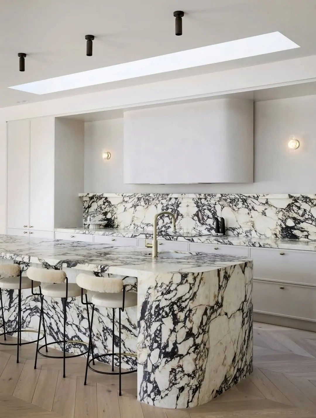 White Kitchen With Cane Stools and Patterned Tile