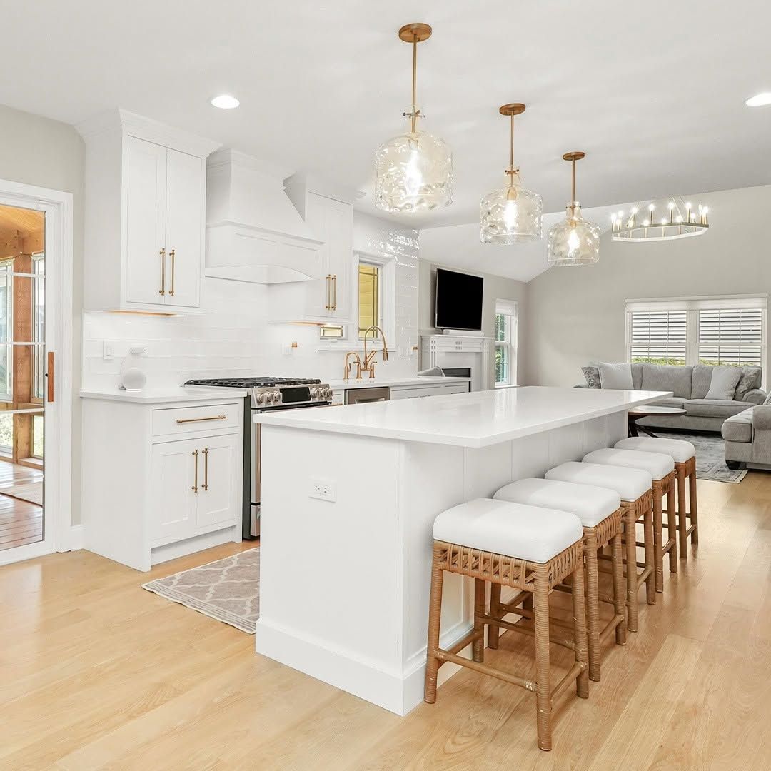 White Kitchen With Cane Stools and Patterned Tile
