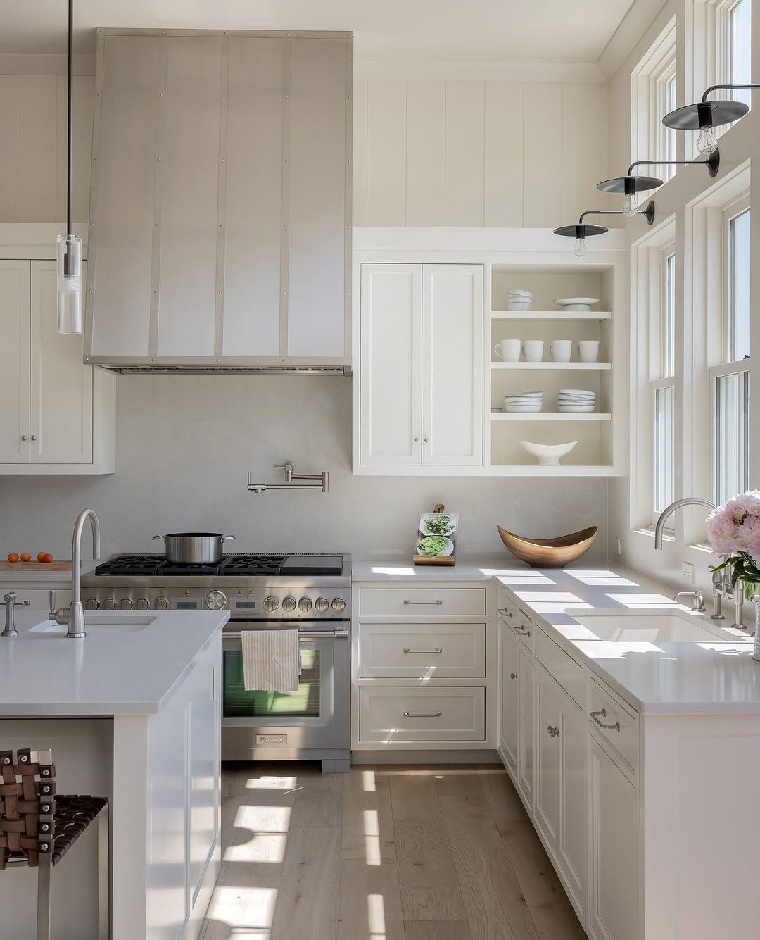White Kitchen With Cane Stools and Patterned Tile