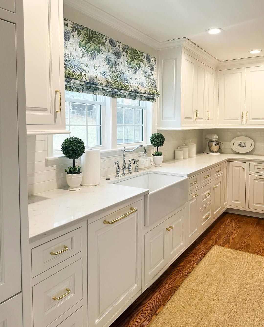 White Kitchen With Cane Stools and Patterned Tile