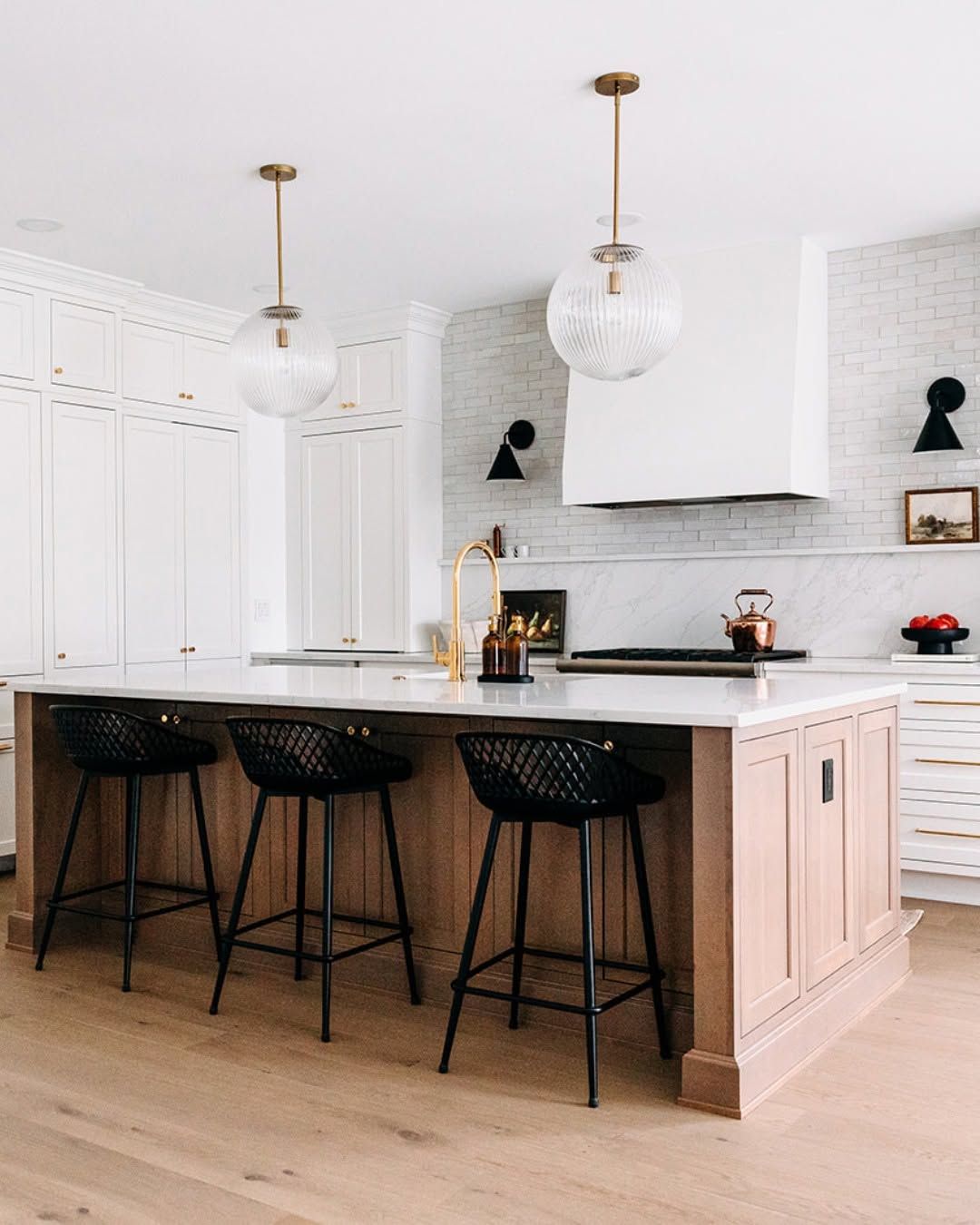 White Kitchen With Cane Stools and Patterned Tile