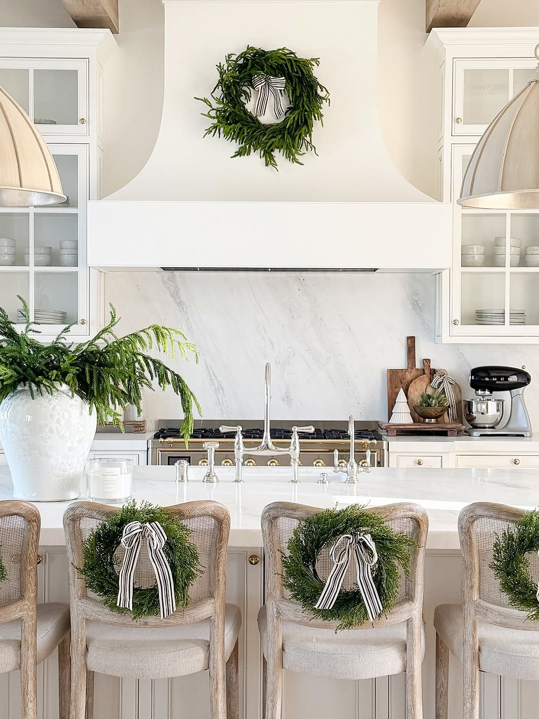 White Kitchen With Cane Stools and Patterned Tile