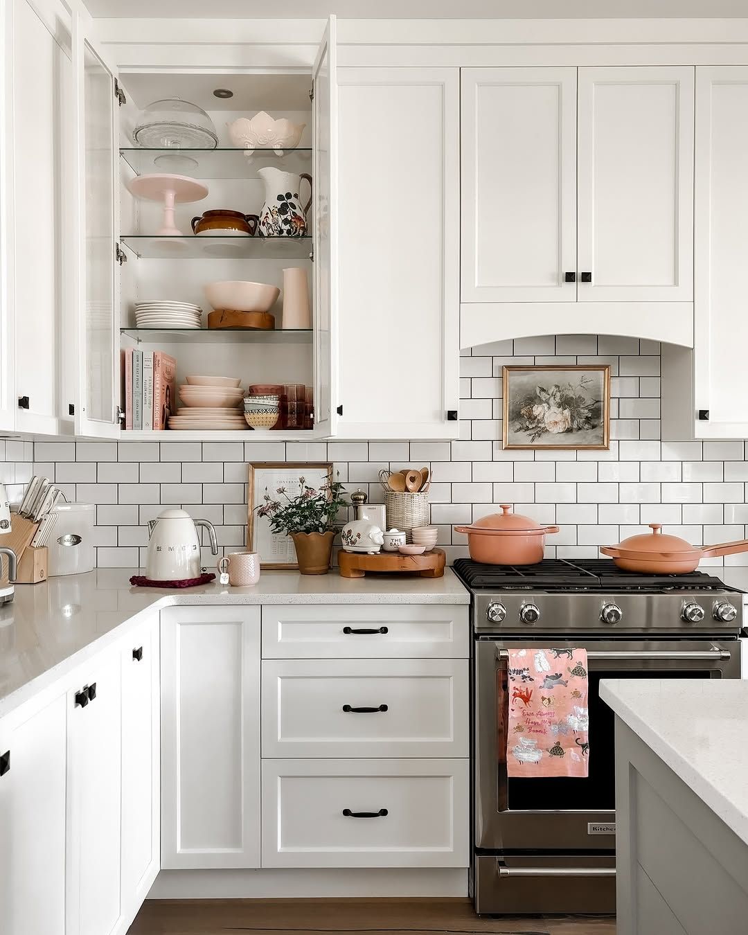 White Kitchen With Cane Stools and Patterned Tile