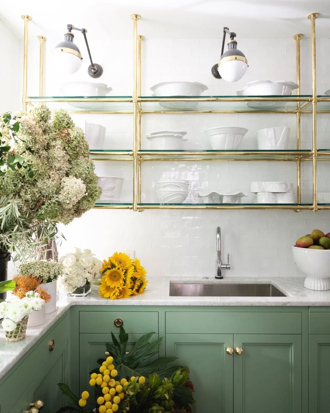 Brass shelving that holds its own against patterned tile
