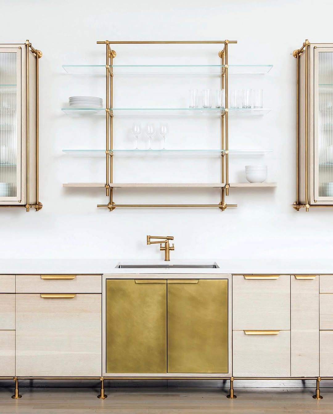 Brass shelving that holds its own against patterned tile
