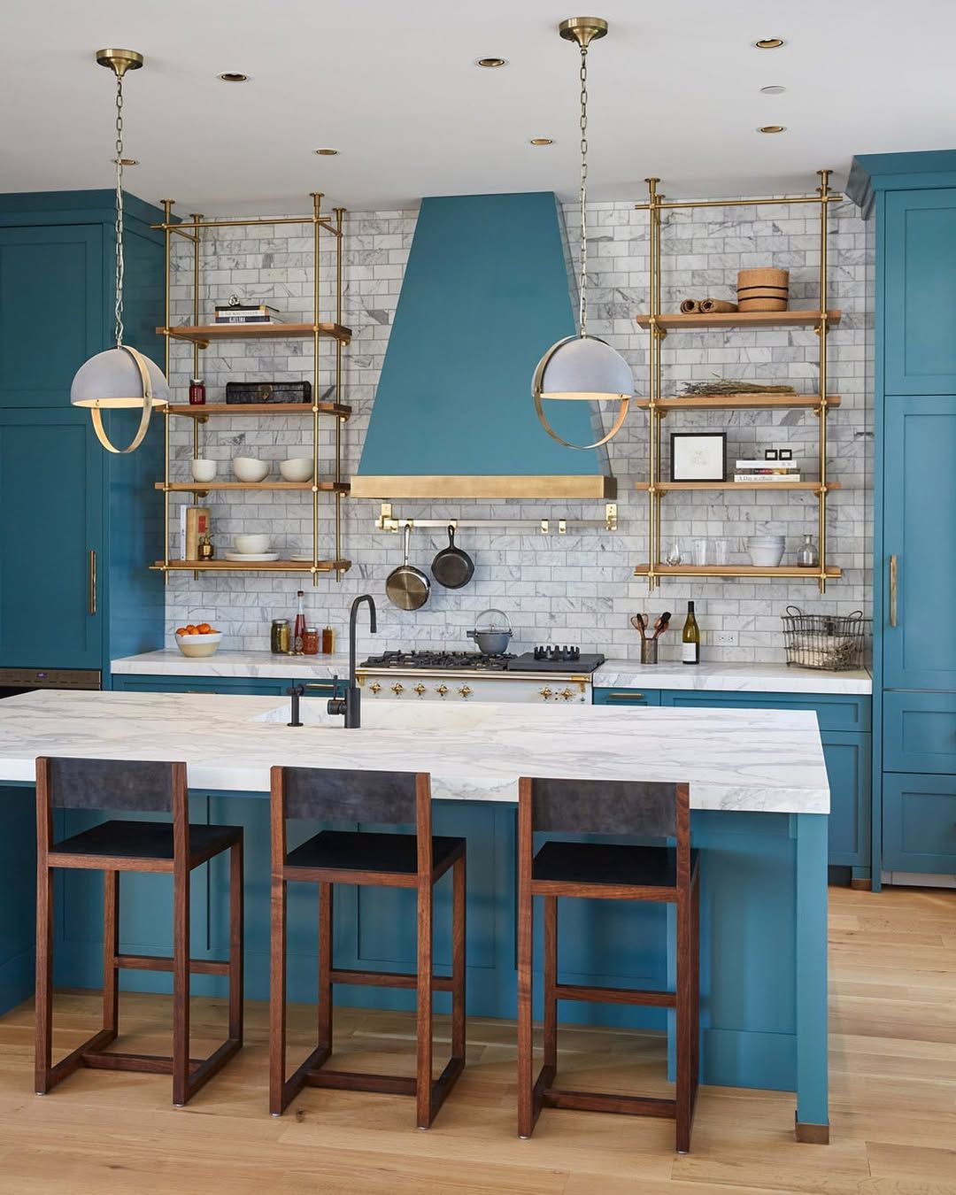 Brass shelving that holds its own against patterned tile