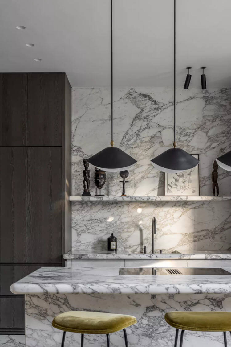 Continuous stone surfaces that merge counter and wall
