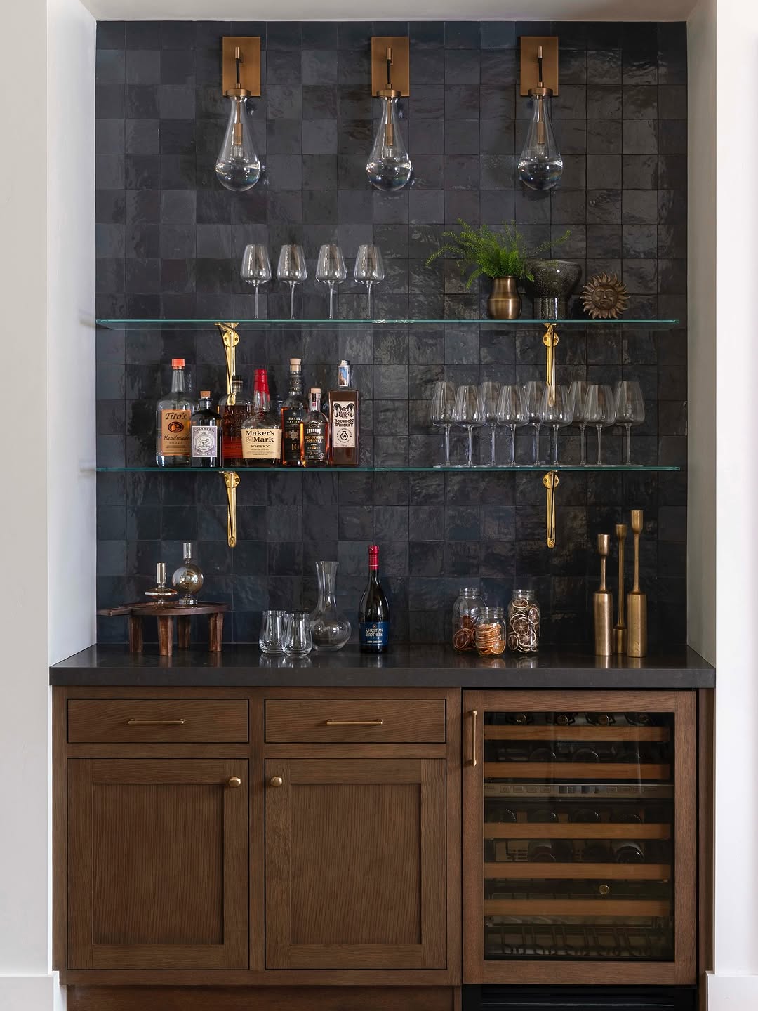Glass shelves that sit comfortably against dark, textured walls