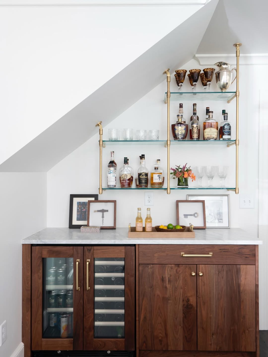 Glass shelves that turn an unused wall into a working bar zone
