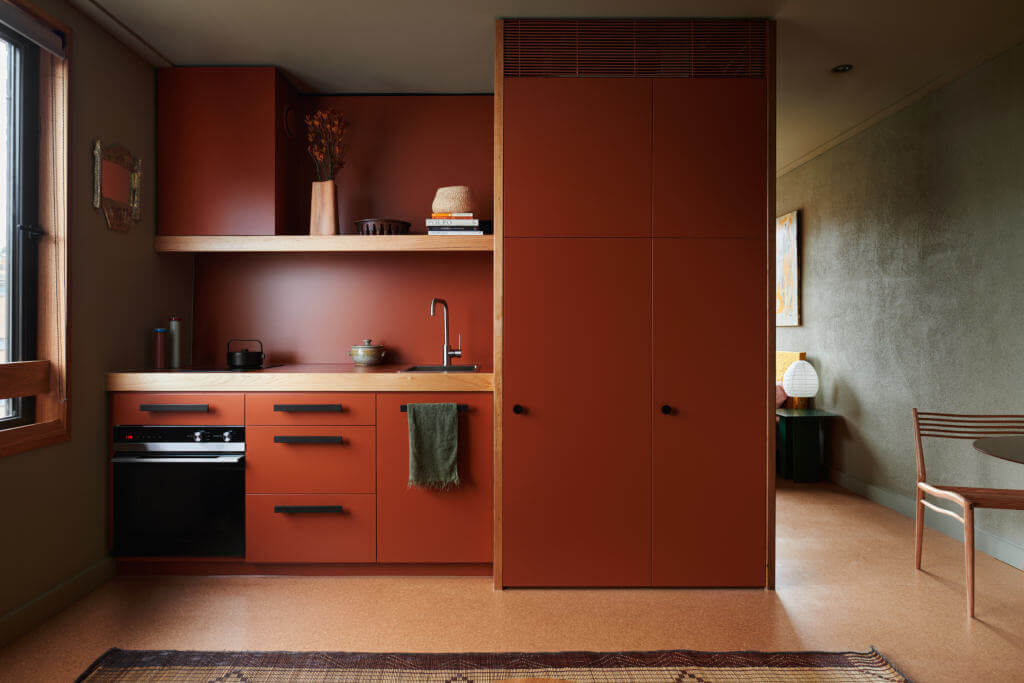 Using cabinet material to cover the wall behind the counter